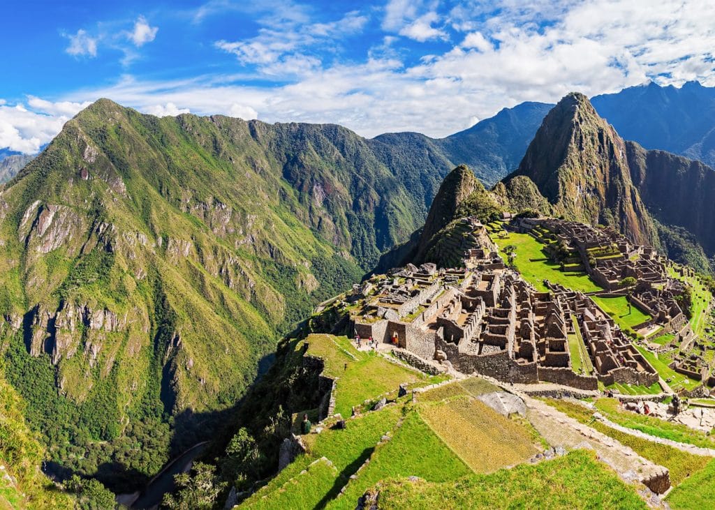 El entorno dramático de Machu Picchu: Terrazas agrícolas y construcciones incas enclavadas sobre el pico, con vistas al cañón y la selva.
